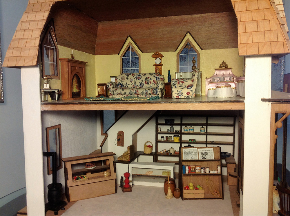 Photo of a dollhouse interior with a livingroom upstairs and a hobbyroom/basement downstairs
